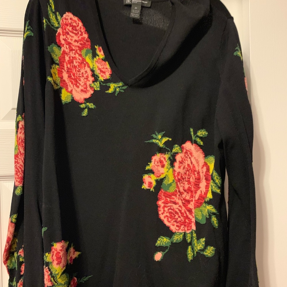 Black v neck sweater with rose design. Bell sleeve